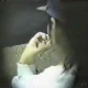 A voyeur-type video in which we view a woman pooping from a hole in the wall.